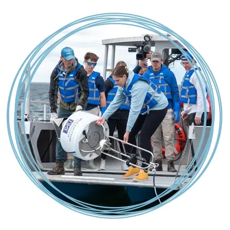 A group of Marine Science students deploy a shark detection buoy into the Atlantic Ocean